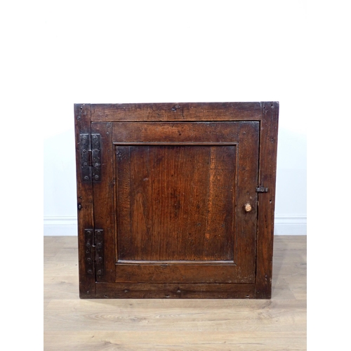 691 - An early 18th Century oak Food Cupboard with single solid panelled door and pierced sides, 2ft 1in W