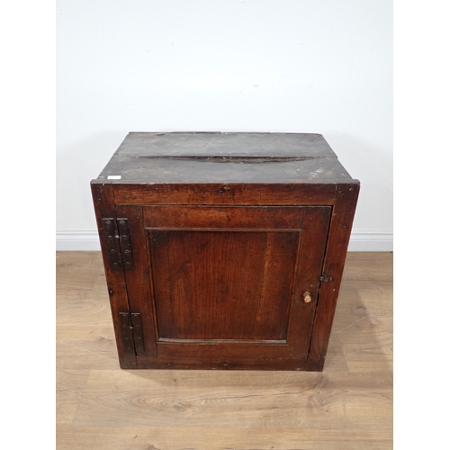 691 - An early 18th Century oak Food Cupboard with single solid panelled door and pierced sides, 2ft 1in W