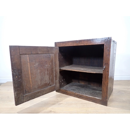 691 - An early 18th Century oak Food Cupboard with single solid panelled door and pierced sides, 2ft 1in W