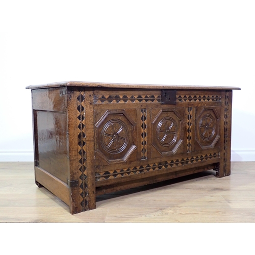 694 - A 17th Century oak Coffer with three panels to the hinged lid, three octagonal recessed panels to th... 