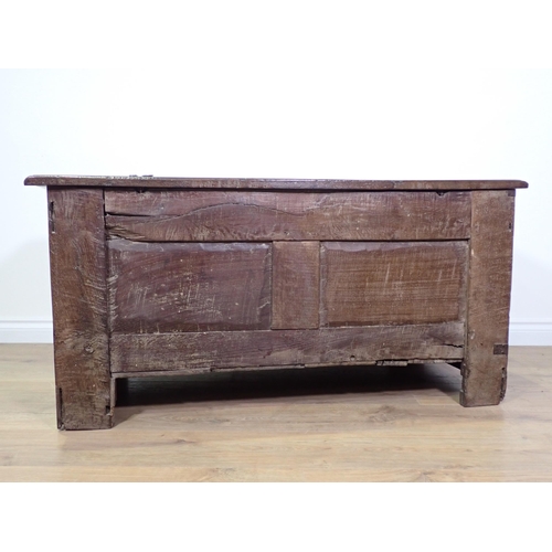 694 - A 17th Century oak Coffer with three panels to the hinged lid, three octagonal recessed panels to th... 