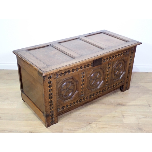 694 - A 17th Century oak Coffer with three panels to the hinged lid, three octagonal recessed panels to th... 