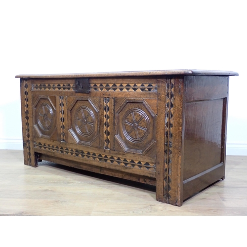 694 - A 17th Century oak Coffer with three panels to the hinged lid, three octagonal recessed panels to th... 