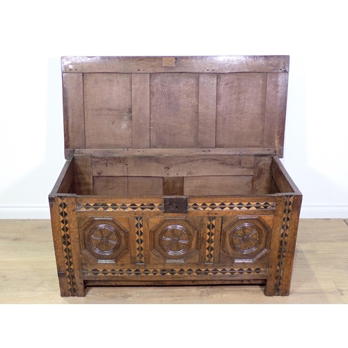 694 - A 17th Century oak Coffer with three panels to the hinged lid, three octagonal recessed panels to th... 