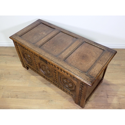 694 - A 17th Century oak Coffer with three panels to the hinged lid, three octagonal recessed panels to th... 