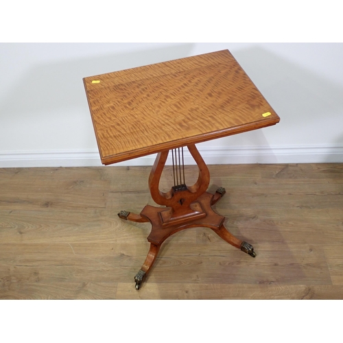 699 - A 19th Century satinwood Occasional Table with rectangular top on lyre support, the quadruple base w... 