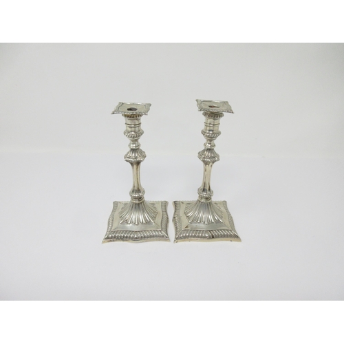 79 - A pair of Edward VII silver Tapersticks with knopped stems on shaped square bases, London 1902, 5in