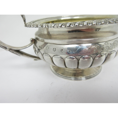 92 - A George III Scottish silver circular Milk Jug with gadroon body, leafage scroll handle, Edinburgh 1... 