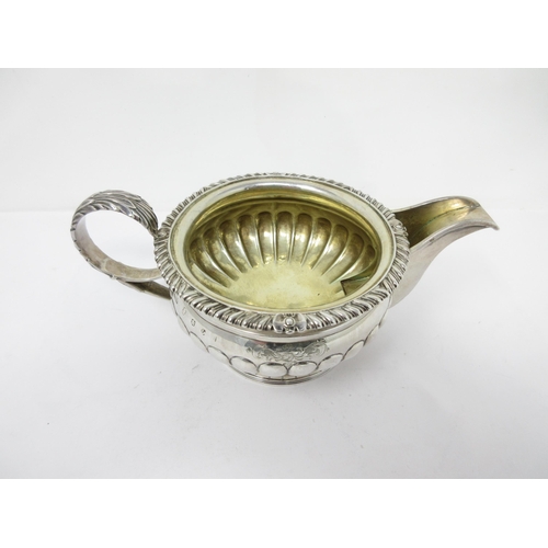 92 - A George III Scottish silver circular Milk Jug with gadroon body, leafage scroll handle, Edinburgh 1... 