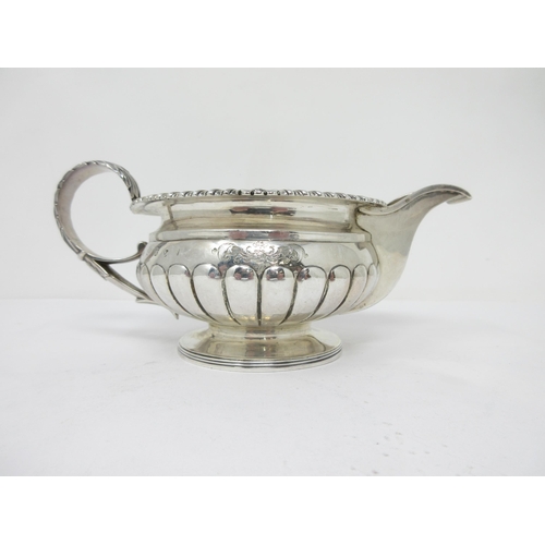 92 - A George III Scottish silver circular Milk Jug with gadroon body, leafage scroll handle, Edinburgh 1... 