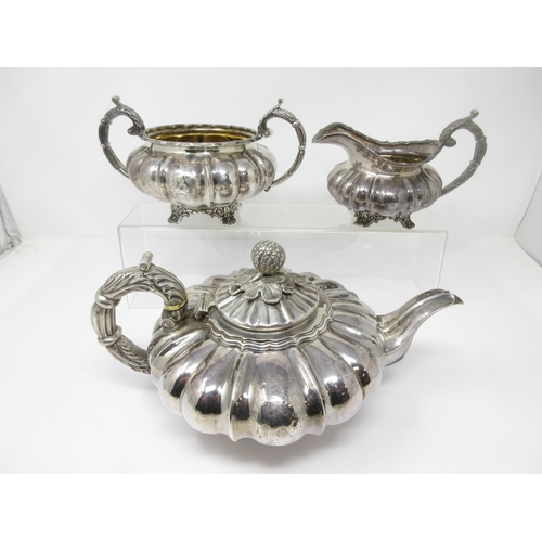 93 - A George IV silver three piece Tea Service of melon shape, engraved shield crest and motto, London 1... 