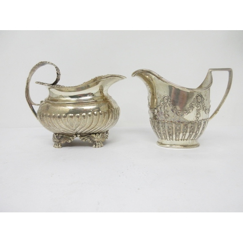 95 - An Edward VII silver Milk Jug of boat shape with gadroon body on anthemion and paw feet, London 1908... 