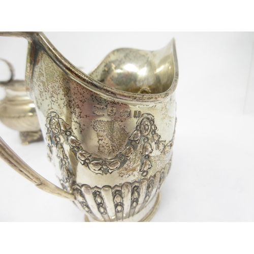 95 - An Edward VII silver Milk Jug of boat shape with gadroon body on anthemion and paw feet, London 1908... 