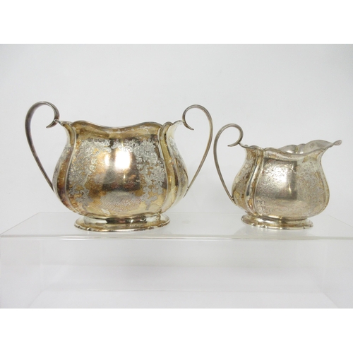 97 - A Victorian silver three piece Tea Service of bulbous form engraved flowers and leafage scrolls, She... 