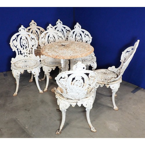 536 - A set of seven white painted cast iron Garden Chairs and a Table (2ft diam.), with pierced and scrol... 