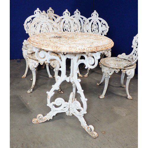 536 - A set of seven white painted cast iron Garden Chairs and a Table (2ft diam.), with pierced and scrol... 