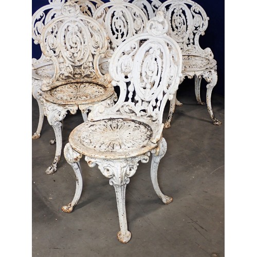 536 - A set of seven white painted cast iron Garden Chairs and a Table (2ft diam.), with pierced and scrol... 