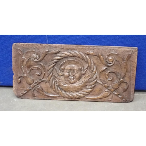 676 - A 16th Century oak Panel carved central mask within rope work and flanked by leafage scrolls 17 1/2i... 