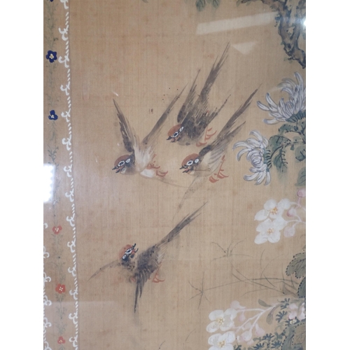 430 - A pair of Oriental silk Pictures decorated various birds on a floral branch with a decorative border