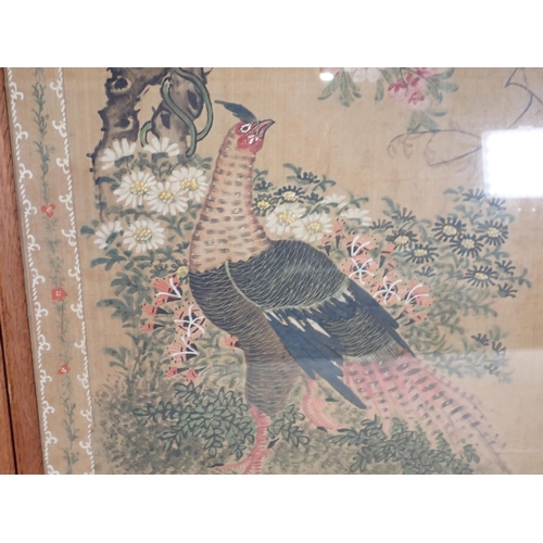 430 - A pair of Oriental silk Pictures decorated various birds on a floral branch with a decorative border