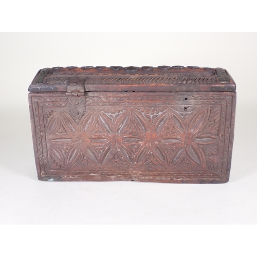 488 - A carved Box, possibly Indian, with a carved, hinged cover with metal mounts, the front carved with ... 