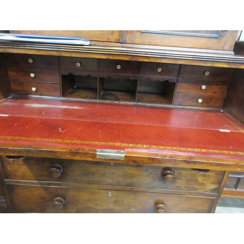 546 - An early 19th Century yew wood Secretaire Bookcase, the upper section with raised moulded panelled d... 