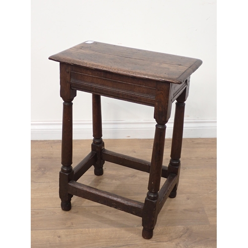 73 - A 17th Century oak Joint Stool with moulded top and frieze on turned tapering supports and squared s... 