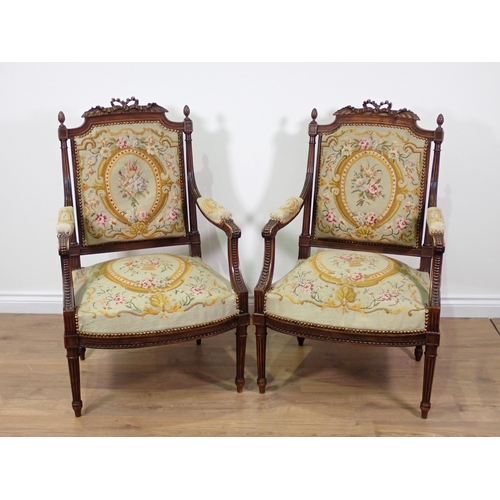 32 - A pair of French walnut Elbow Chairs with finely carved ribbon surmounts and pineapple finials, flut... 