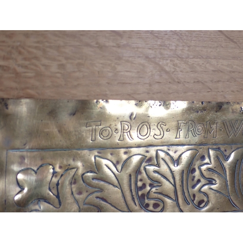 282 - A Keswick School embossed brass Panel having a design of intertwining foliage, with inscription to t... 