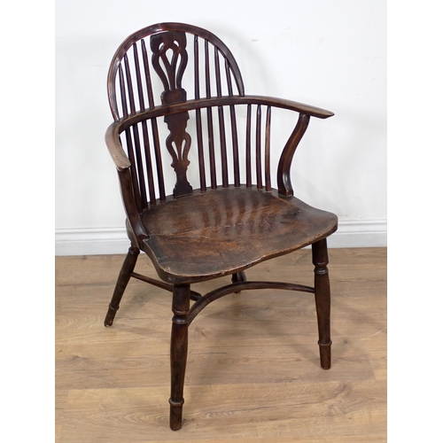 605 - An early 19th Century yew and elm Windsor Elbow Chair with pierced splat back, on turned supports an... 