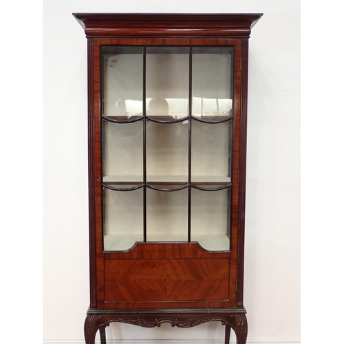 10 - An Edwardian glazed Display Cabinet with single door enclosing shelves and raised on carved cabriole... 