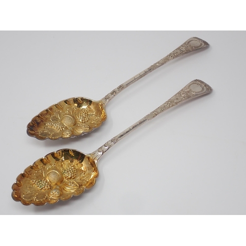 106 - A pair of George III silver and parcel-gilt Table Spoons with fruit embossed bowls, London 1820, mak... 