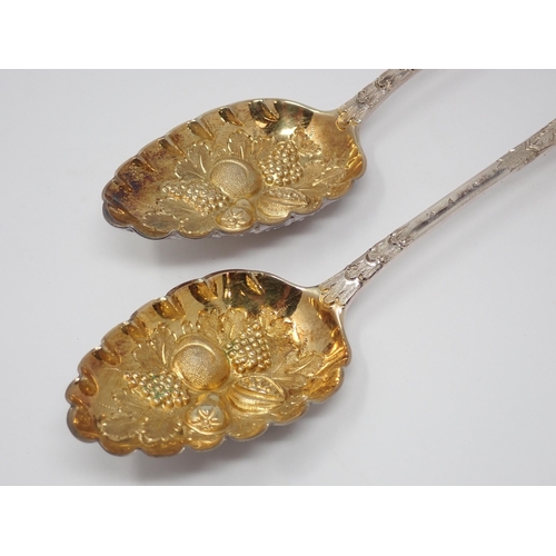 106 - A pair of George III silver and parcel-gilt Table Spoons with fruit embossed bowls, London 1820, mak... 