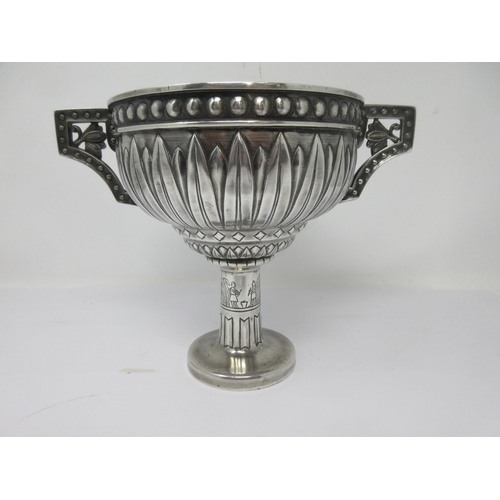 148 - A George V silver Arts & Crafts two-handled Cup with leafage and stud friezes, the column decorated ... 