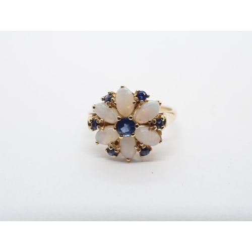 180 - ** WITHDRAWN ** A Sapphire and Opal Flower Cluster Ring claw-set round sapphire within six oval opal... 