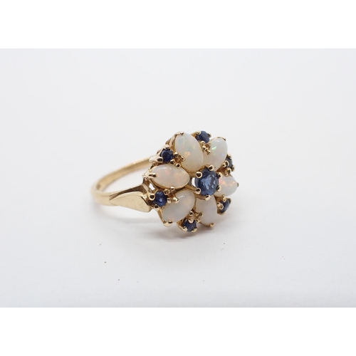 180 - ** WITHDRAWN ** A Sapphire and Opal Flower Cluster Ring claw-set round sapphire within six oval opal... 