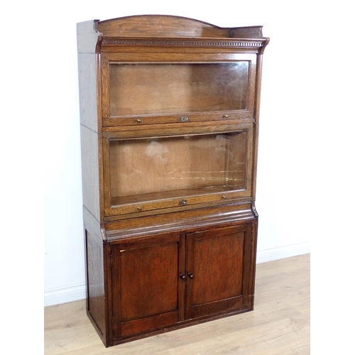 2 - A Lebus oak Bookcase with two glazed doors above a pair of cupboard doors to base, 5ft 4in H x 2ft 1... 