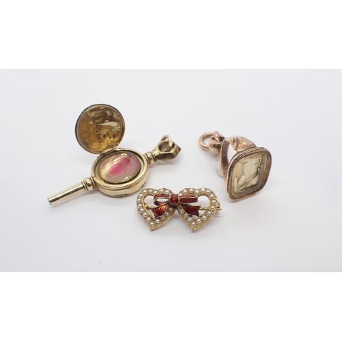 201 - ** WITHDRAWN ** A Seed Pearl and Enamel interlocking heart Brooch in 9ct gold, an Intaglio Seal Fob ... 