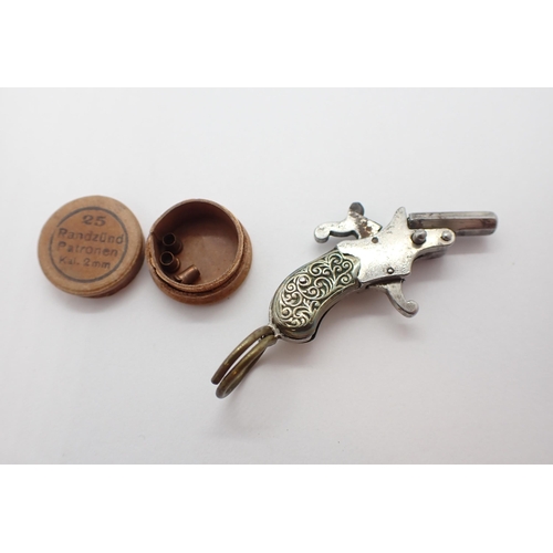 228 - ** WITHDRAWN ** A miniature white metal Pistol