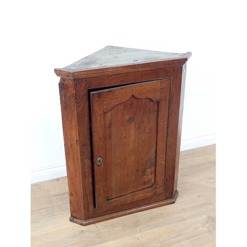 23 - A 19th oak hanging Corner Cupboard with single panelled door, 3ft 1in H