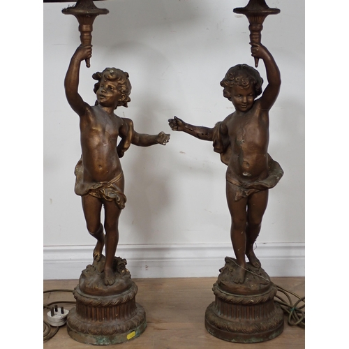 309 - A pair of bronze effect Table Lamps and shades in the form of cherubs A/F 3ft 4in H, passed PAT