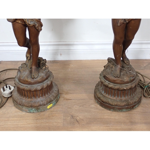 309 - A pair of bronze effect Table Lamps and shades in the form of cherubs A/F 3ft 4in H, passed PAT