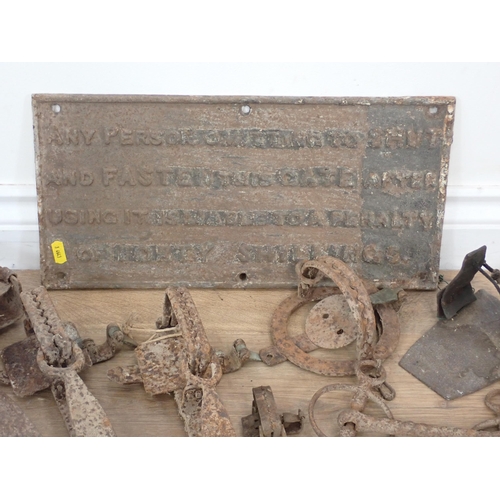 334 - A cast iron Sign, a Steel Yard, and a quantity of traps