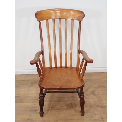 337 - A beech and elm Windsor Elbow Chair with baluster turned supports and stretchers