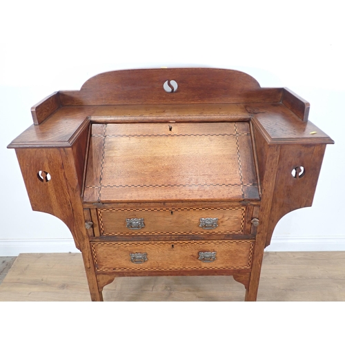 354 - An Arts and Crafts Desk with sloping front and two drawers with chequered inlay on squared supports,... 