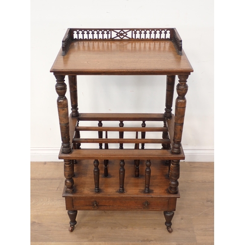 48 - A Victorian walnut Canterbury with raised upper shelf on turned supports surmounted by Gothic arch p... 