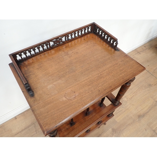 48 - A Victorian walnut Canterbury with raised upper shelf on turned supports surmounted by Gothic arch p... 