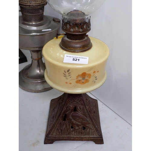 521 - A large Oil Lamp with engraved clear glass reservoir and two paraffin Lamps