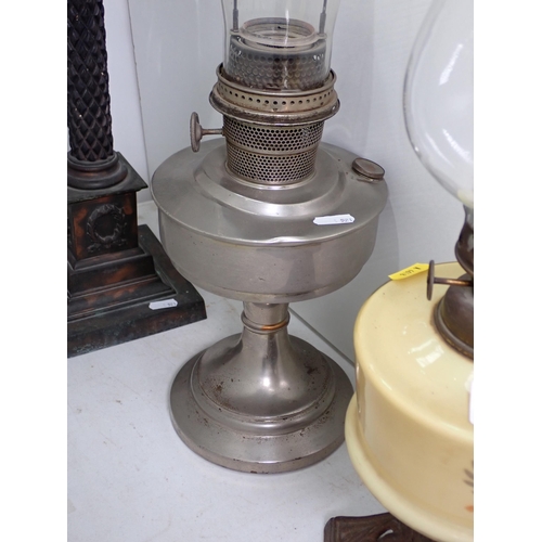 521 - A large Oil Lamp with engraved clear glass reservoir and two paraffin Lamps