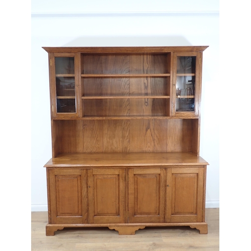 540 - A modern oak Dresser and rack fitted four fielded cupboard doors to base 6ft 2in H x 5ft 4in W